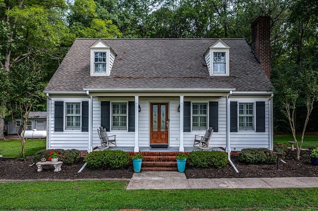 3503 Canal Rd, Farnham, VA 22460 - new england style home with a chimney, a porch, a front yard, and a shingled roof