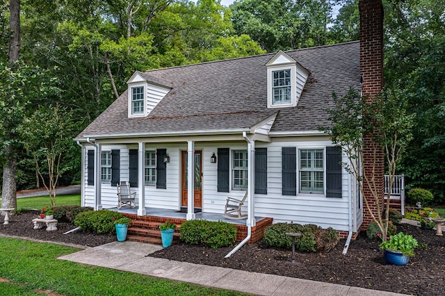 3503 Canal Rd, Farnham, VA 22460 - cape cod house featuring a chimney, a porch, roof with shingles, and view of wooded area