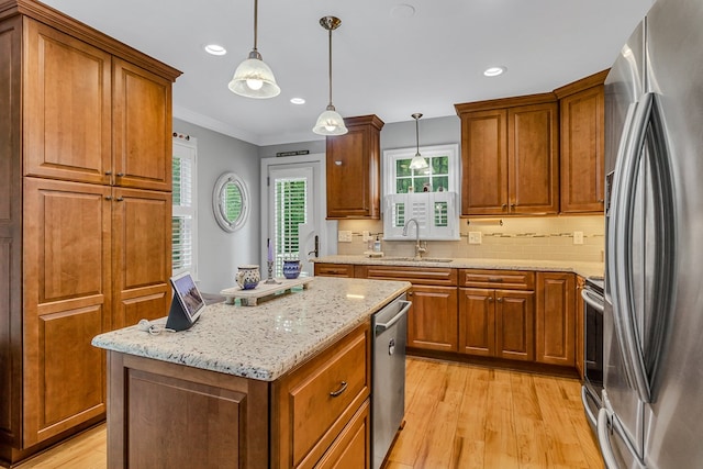 3503 Canal Rd, Farnham, VA 22460 - kitchen featuring stainless steel appliances, light wood finished floors, brown cabinetry, ornamental molding, and recessed lighting