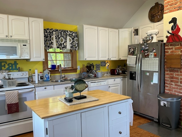 2884 Lake Rd, Lottsburg, VA 22511 - kitchen featuring white appliances, butcher block countertops, a sink, white cabinetry, and a kitchen island