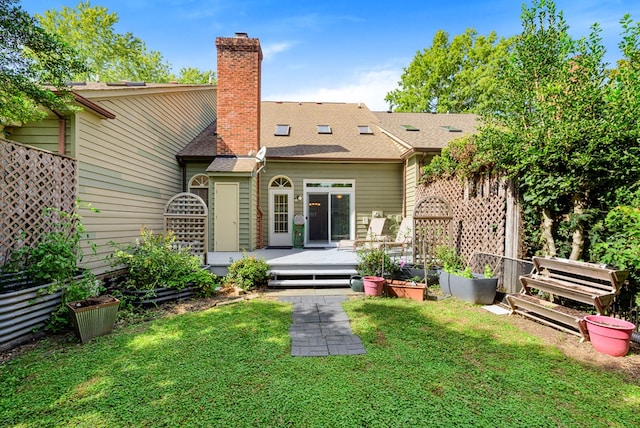 10 Heatherfield Ct, Kilmarnock, VA 22482 - rear view of property featuring a wooden deck, a chimney, and a lawn