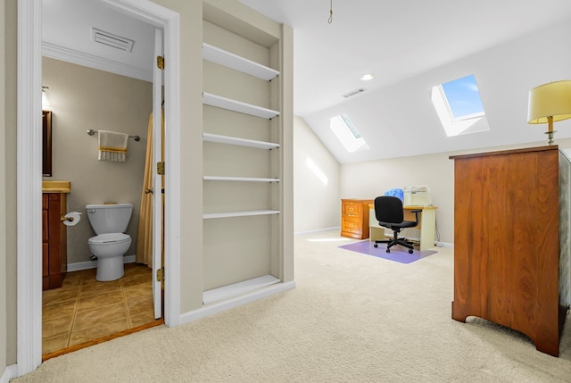 10 Heatherfield Ct, Kilmarnock, VA 22482 - carpeted home office featuring a skylight, built in shelves, and lofted ceiling