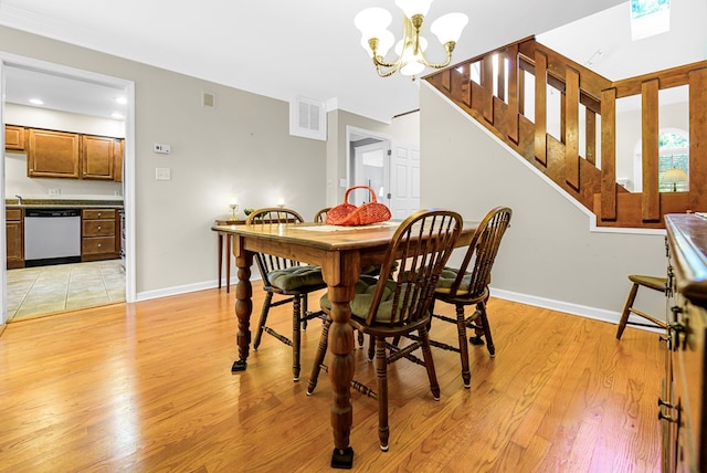 10 Heatherfield Ct, Kilmarnock, VA 22482 - dining area with light wood-style flooring, a chandelier, ornamental molding, and stairs