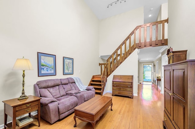 10 Heatherfield Ct, Kilmarnock, VA 22482 - living area featuring a towering ceiling, light wood-style floors, and stairway