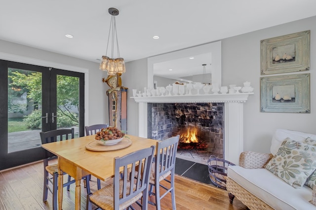 1083 Ottoman Ferry Rd, Lancaster, VA 22503 - dining area featuring hardwood / wood-style floors, a fireplace with flush hearth, french doors, and recessed lighting