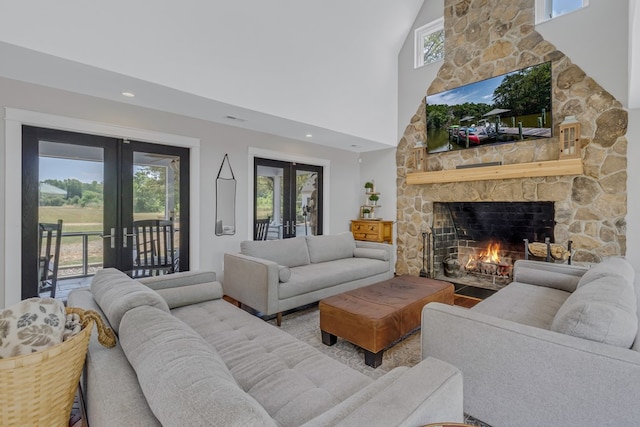 1083 Ottoman Ferry Rd, Lancaster, VA 22503 - living room with french doors, a fireplace, a towering ceiling, and wood finished floors