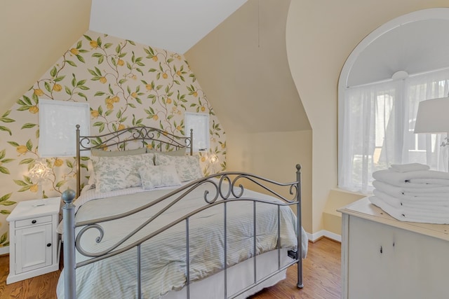 1083 Ottoman Ferry Rd, Lancaster, VA 22503 - bedroom with vaulted ceiling, wood finished floors, baseboards, and wallpapered walls