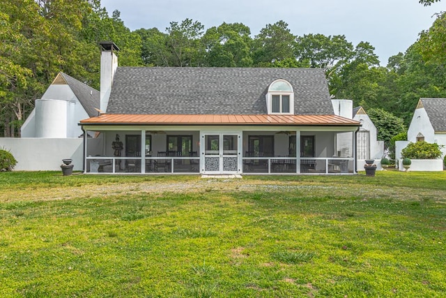 1083 Ottoman Ferry Rd, Lancaster, VA 22503 - rear view of property with a sunroom, a standing seam roof, metal roof, and a chimney