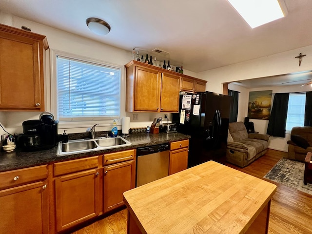 701 Lewis St, Tappahannock, VA 22560 - kitchen featuring stainless steel dishwasher, black refrigerator with ice dispenser, open floor plan, light wood-style floors, and wood counters