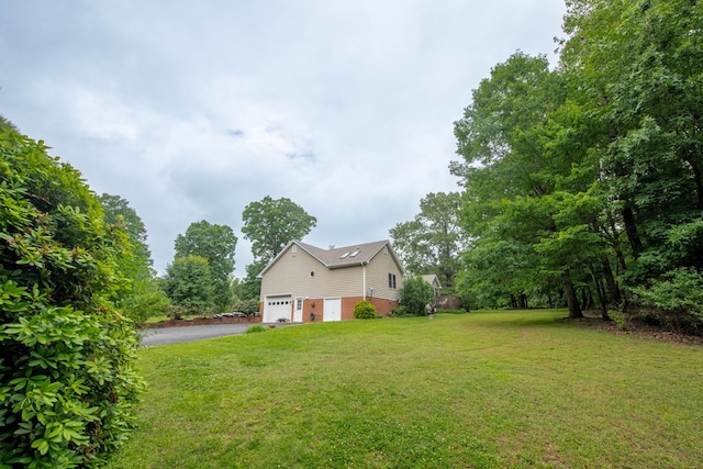 1851 Desha Rd, Tappahannock, VA 22560 - view of green lawn with asphalt driveway and an attached garage