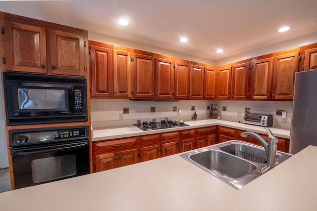 1851 Desha Rd, Tappahannock, VA 22560 - kitchen with black appliances, a sink, light countertops, brown cabinets, and recessed lighting