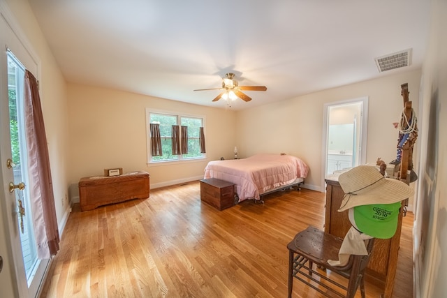 1851 Desha Rd, Tappahannock, VA 22560 - bedroom featuring light wood-style floors, baseboards, ceiling fan, and ensuite bath