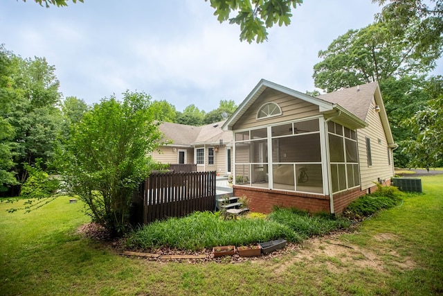 1851 Desha Rd, Tappahannock, VA 22560 - back of property with a sunroom, central air condition unit, a yard, and brick siding