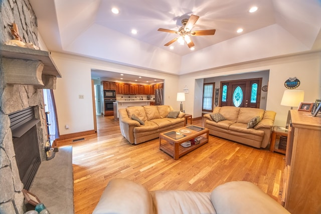 1851 Desha Rd, Tappahannock, VA 22560 - living area featuring a tray ceiling, a fireplace, light wood-style floors, ceiling fan, and recessed lighting