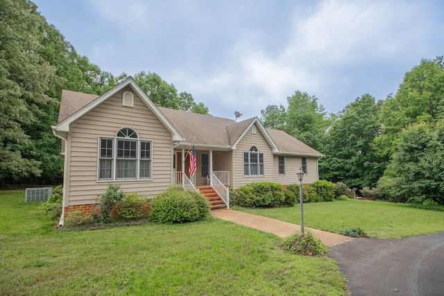 1851 Desha Rd, Tappahannock, VA 22560 - ranch-style house with covered porch, a front yard, a shingled roof, and central AC unit