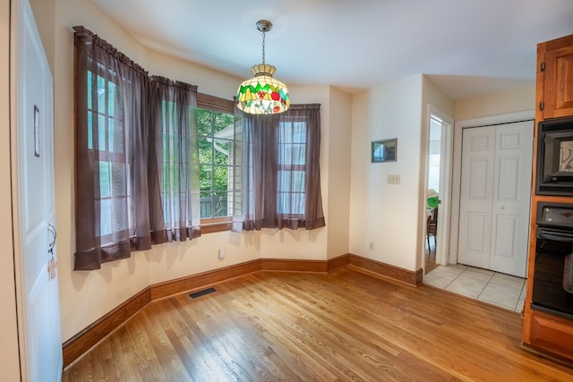 1851 Desha Rd, Tappahannock, VA 22560 - unfurnished dining area with baseboards and light wood-type flooring
