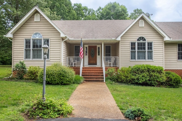 1851 Desha Rd, Tappahannock, VA 22560 - single story home featuring covered porch, a front lawn, a shingled roof, and brick siding
