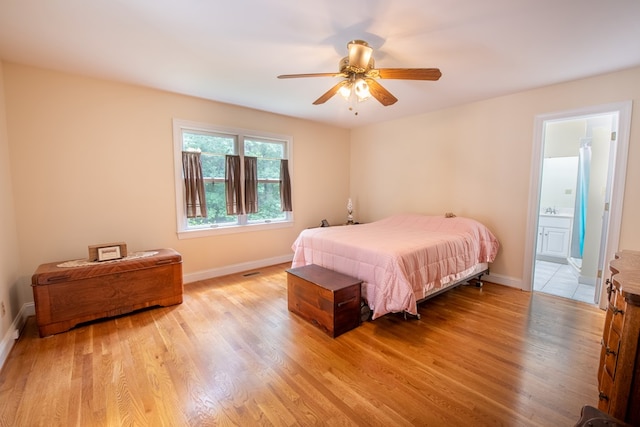 1851 Desha Rd, Tappahannock, VA 22560 - bedroom with light wood-style floors, baseboards, ensuite bath, and ceiling fan