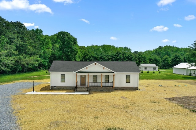 2976 Newmans Neck Rd, Heathsville, VA 22473 - modern farmhouse style home featuring crawl space, a porch, a view of trees, and roof with shingles
