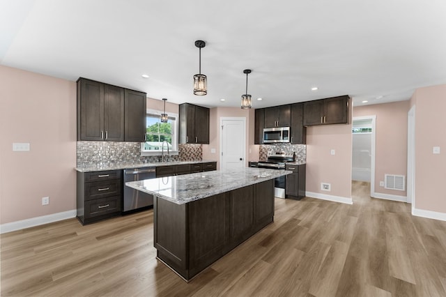 2976 Newmans Neck Rd, Heathsville, VA 22473 - kitchen featuring appliances with stainless steel finishes, a sink, light wood finished floors, tasteful backsplash, and recessed lighting