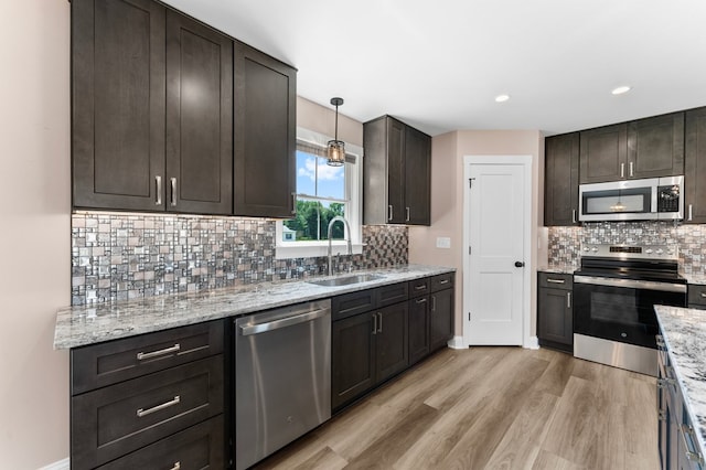2976 Newmans Neck Rd, Heathsville, VA 22473 - kitchen with appliances with stainless steel finishes, a sink, light wood-style floors, tasteful backsplash, and recessed lighting