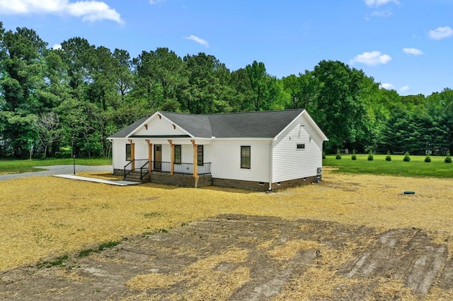 2976 Newmans Neck Rd, Heathsville, VA 22473 - modern farmhouse with crawl space, a front lawn, a shingled roof, and a view of trees