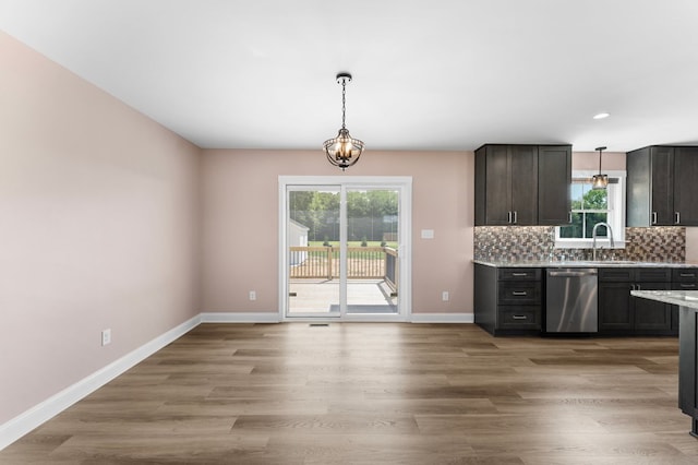 2976 Newmans Neck Rd, Heathsville, VA 22473 - kitchen with dishwasher, decorative light fixtures, a sink, baseboards, and decorative backsplash