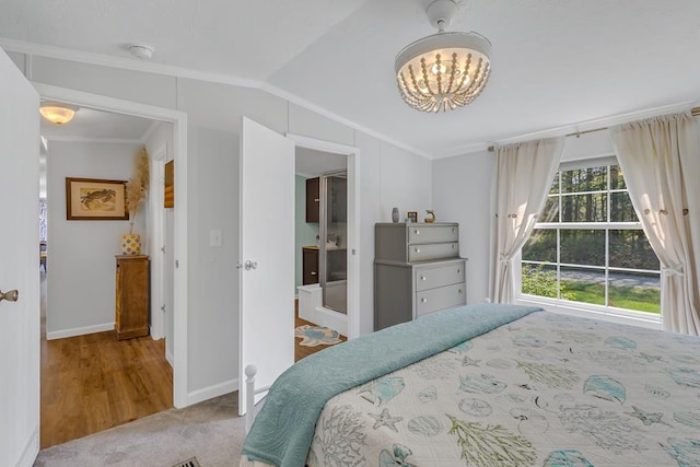 carpeted bedroom with vaulted ceiling, baseboards, a chandelier, and crown molding