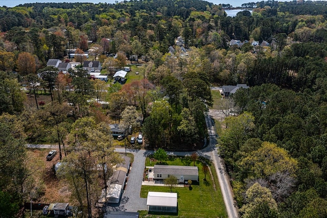 drone / aerial view with a wooded view