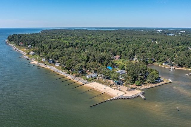 drone / aerial view with a forest view and a water view