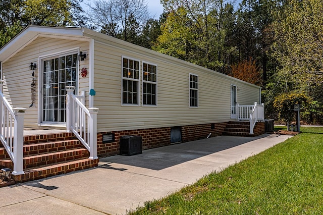 exterior space with crawl space and a patio area