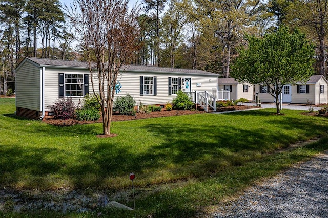 manufactured / mobile home with crawl space and a front lawn