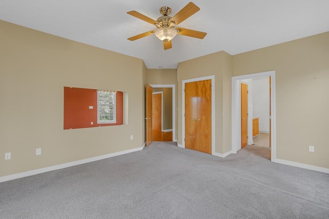 unfurnished bedroom featuring light carpet and ceiling fan