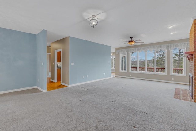 unfurnished living room with light carpet, a fireplace, and ceiling fan