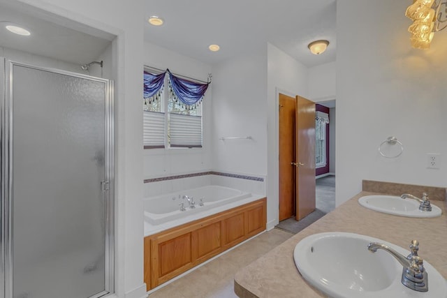 bathroom featuring tile patterned flooring, vanity, and separate shower and tub