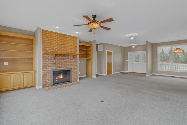 unfurnished living room with a brick fireplace, carpet floors, and ceiling fan