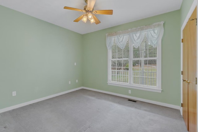 carpeted empty room with ceiling fan