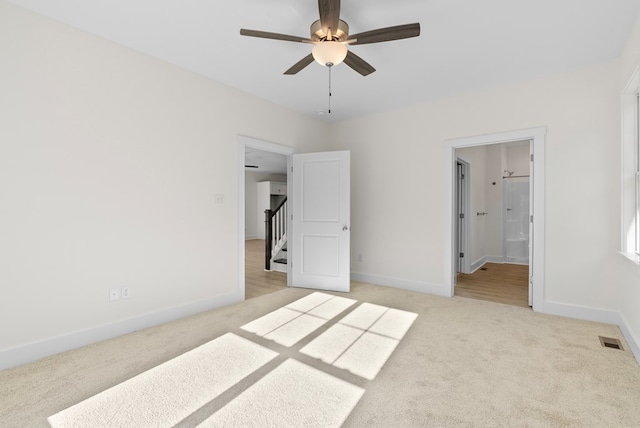 unfurnished bedroom with light colored carpet, visible vents, and baseboards