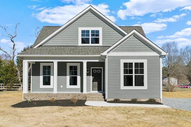 bungalow-style house featuring covered porch and roof with shingles