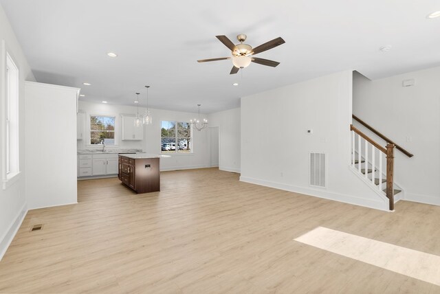 kitchen with white cabinets, ceiling fan, hanging light fixtures, and appliances with stainless steel finishes