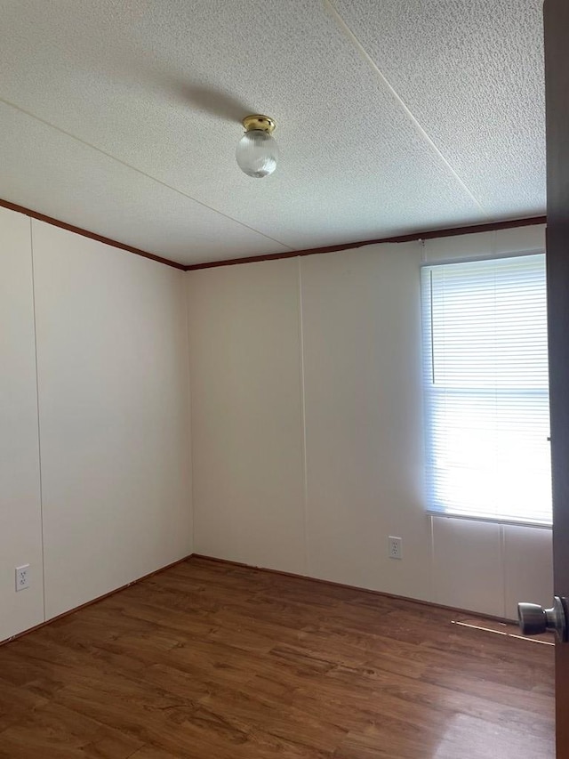 91 Dameron Dr, Hague, VA 22469 - unfurnished room featuring wood finished floors, a textured ceiling, and crown molding