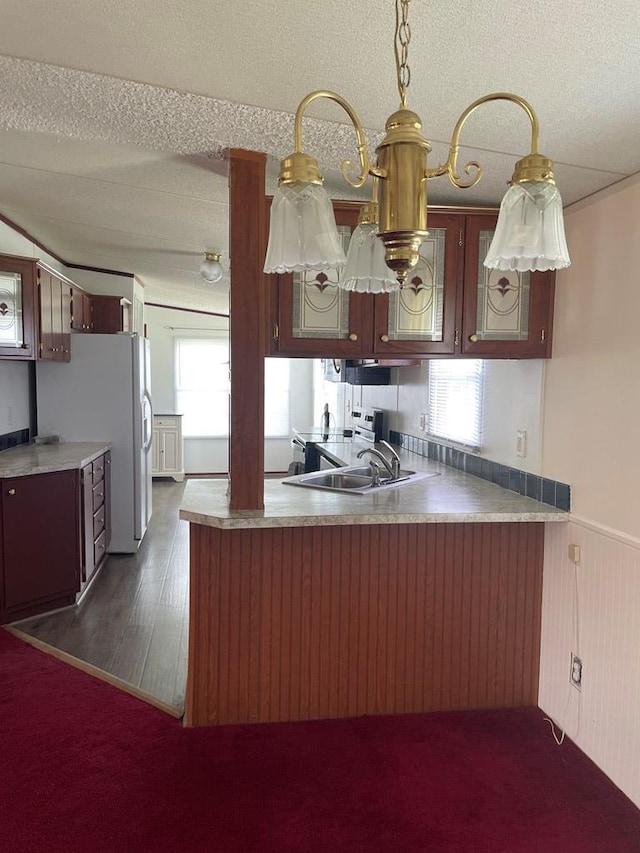 91 Dameron Dr, Hague, VA 22469 - kitchen with a peninsula, plenty of natural light, a textured ceiling, a wainscoted wall, and stainless steel range with electric stovetop