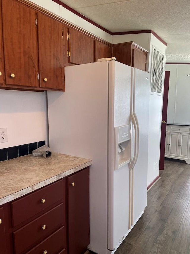 91 Dameron Dr, Hague, VA 22469 - kitchen with white fridge with ice dispenser, dark wood finished floors, light countertops, brown cabinets, and a textured ceiling