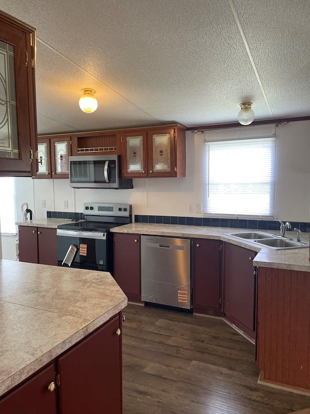 91 Dameron Dr, Hague, VA 22469 - kitchen with appliances with stainless steel finishes, dark wood-style floors, a textured ceiling, light countertops, and glass insert cabinets