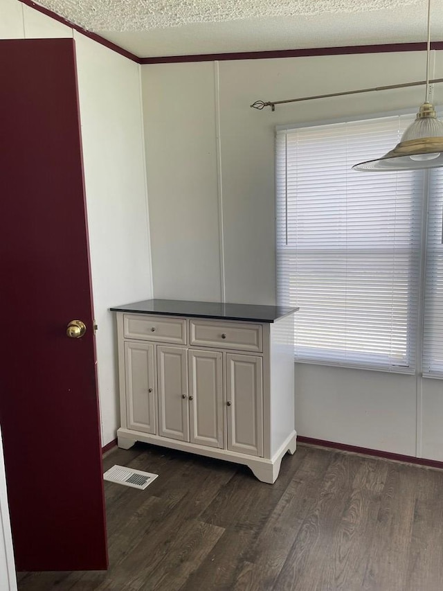 91 Dameron Dr, Hague, VA 22469 - unfurnished dining area featuring dark wood-type flooring and a textured ceiling