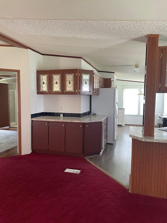 91 Dameron Dr, Hague, VA 22469 - kitchen with a textured ceiling, light countertops, freestanding refrigerator, and dark wood-style flooring