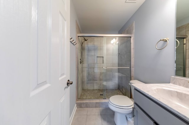 bathroom featuring vanity, toilet, an enclosed shower, and tile patterned flooring