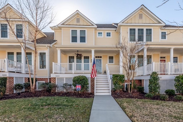 view of front of house with a front yard and ceiling fan