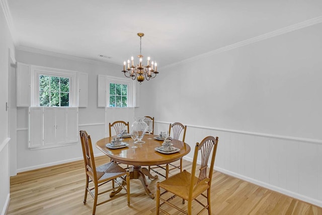 94 Arcadia Dr, Newport News, VA 23608 - dining space with light wood-type flooring, a chandelier, crown molding, and a wainscoted wall