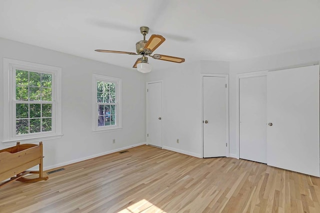 94 Arcadia Dr, Newport News, VA 23608 - unfurnished bedroom featuring light wood-type flooring, multiple closets, and a ceiling fan